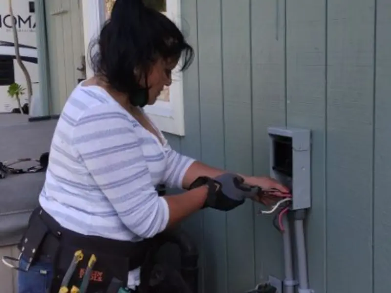 Licensed electrician wiring an exterior subpanel in Avon